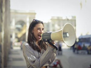 Photo by Andrea Piacquadio: https://www.pexels.com/photo/cheerful-young-woman-screaming-into-megaphone-3761509/